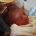New born baby boy crying on head shave on 7th day(Model Release)