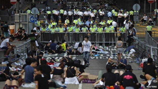 Protesters block a street near government headquarters in Hong Kong on 30 September 2014 