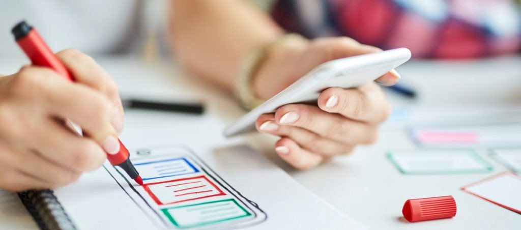 Closeup of designers creating mobile app prototype