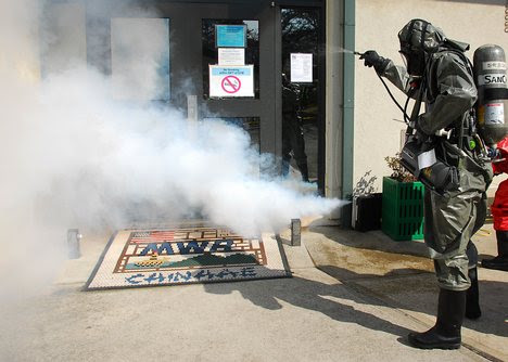 A Republic of Korea chemical company employee washes down a simulated 