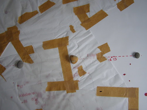 Drawing with body trace (detail), tissue paper with gummed tape,pencil with red ink and beach pebbles on paper. by Russell Moreton
