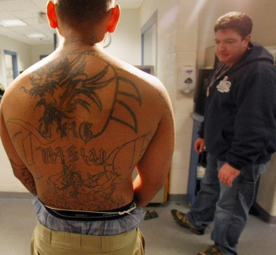A reputed gang member had his tattoos photographed by Lynn officers, 