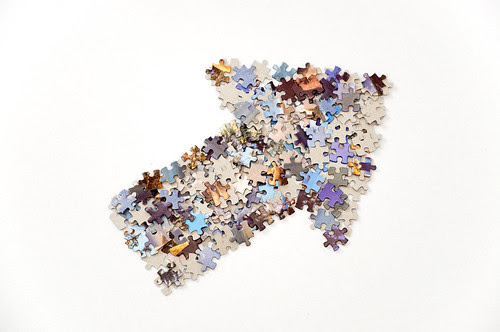 Thick arrow made from jigsaw puzzle pieces