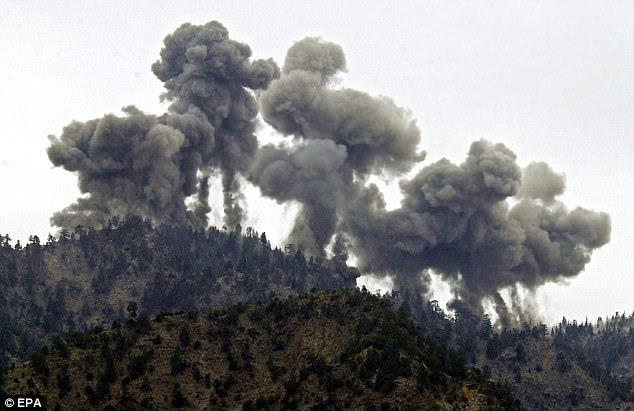 No escape? A multiple explosion rocks Al Qaeda positions in the Tora Bora mountains after an attack by US warplanes in December 2001
