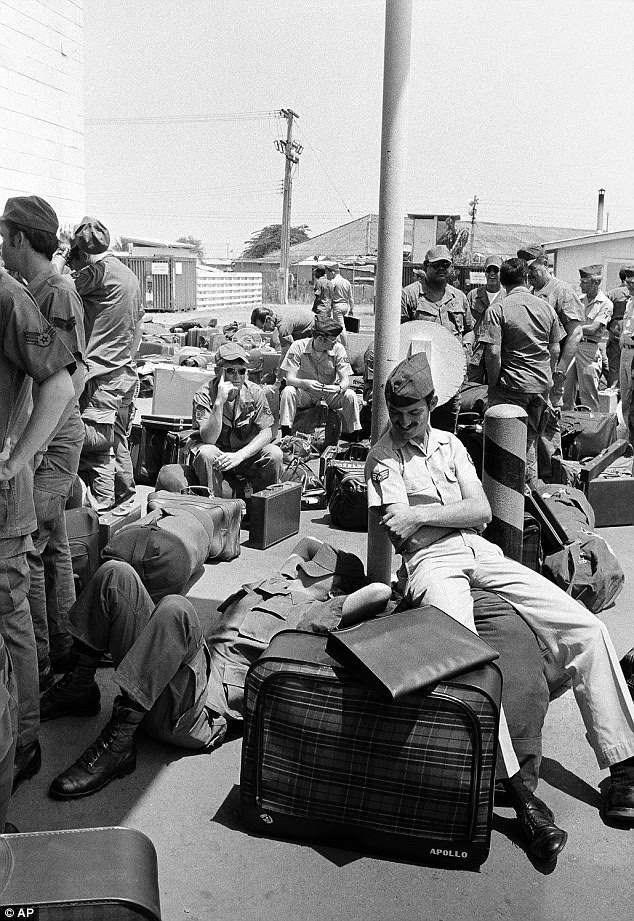 Bored: In this March 27, 1973 photo, an American GI takes a nap atop his luggage as he and other troops wait to begin out processing at Camp Alpha in Saigon