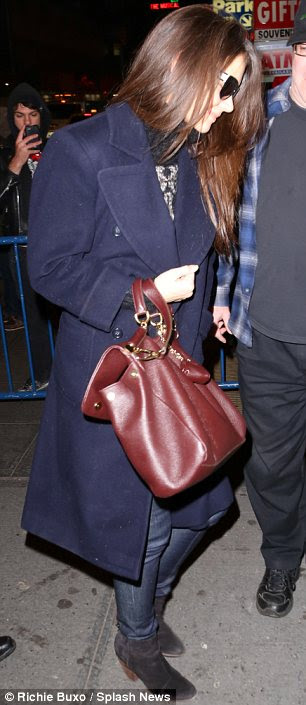 So stylish: a lacy top was spotted under the smiling star's cosy coat as she made her way inside