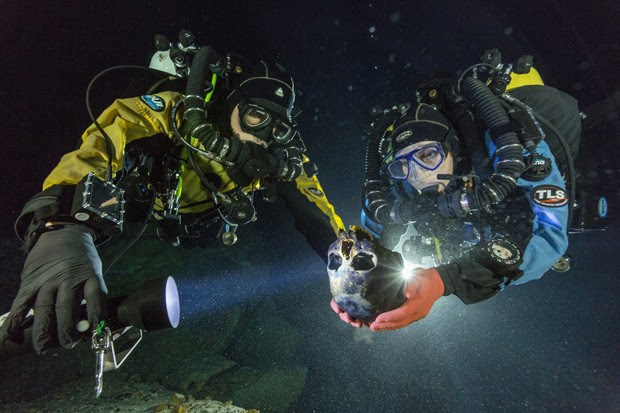  Mergulhadores Alberto Nava e Susan Bird transportam o crânio para uma plataforma giratória, para que ele seja fotografado para a criação de um modelo 3D (Foto:  Cortesia de Paul Nicklen/National Geographic)