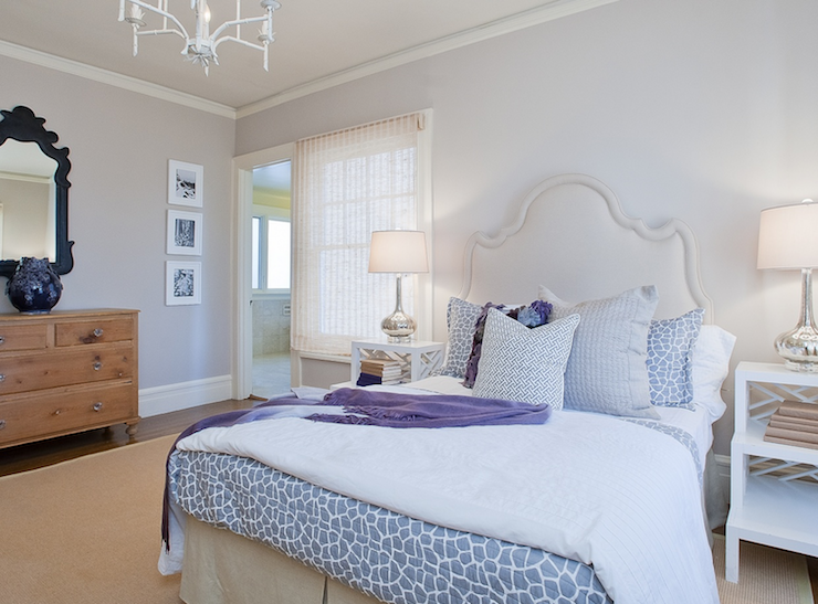 Lilac bedroom with bound sisal rug, white tiered step tables, gray giraffe print