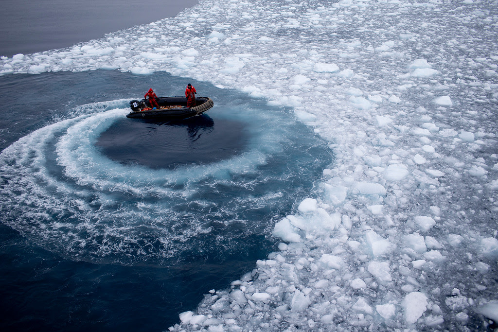 Description of . In this Jan. 22, 2015 photo, Chilean Navy officers push away ice by moving their boat in circles as they approach the Aquiles navy ship where they will pick up international scientists and take them to Chile's scientific Station Bernardo O'Higgins in Antarctica. While tourists come to Antarctica for its beauty and remoteness, scientists are all business. What they find could affect the lives of people thousands of miles away. (AP Photo/Natacha Pisarenko)