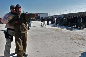 In this photograph taken  Jan. 31, 2007, Afghan men are trained by  U.S. military contractors  during a exercise in the southern town of  Qalat, the capital of Zabul  province. A new government report shows the  number of contractor deaths  in Afghanistan has increased in recent  months. (Shah Marai/AFP/Getty  Images)