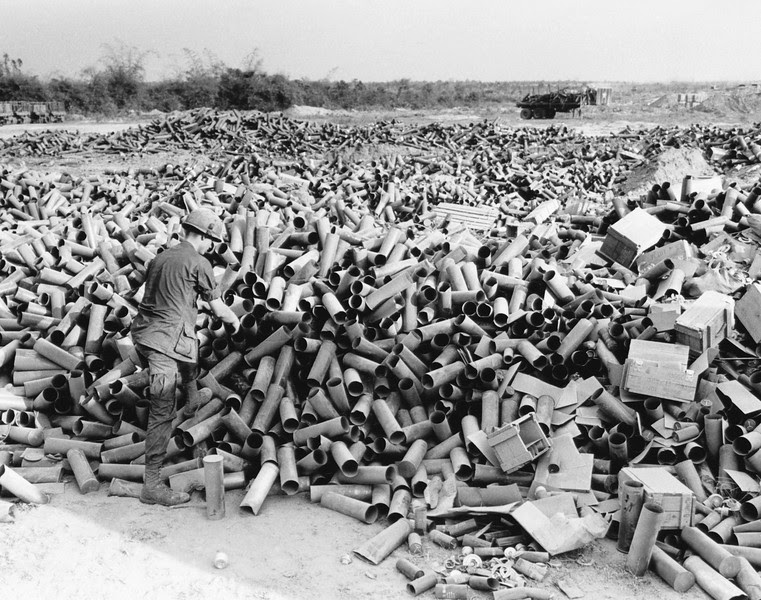 Description of  Empty artillery cartridges pile up at the artillery base at Soui Da, some 60 miles northwest of Saigon, at the southern edge of War Zone C, on March 8, 1967. (AP Photo/Horst Faas)