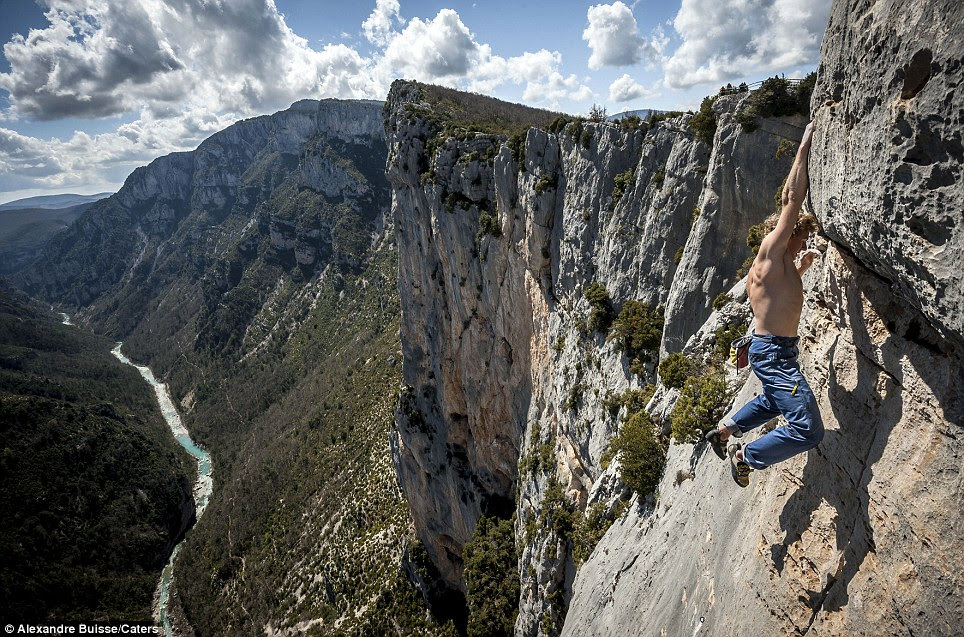 Newfangled dangle: Free-climber Mich Kemeter hangs over the edge of a 500ft cliff in the Verdon National Park, France, by the tips of his fingers without any ropes