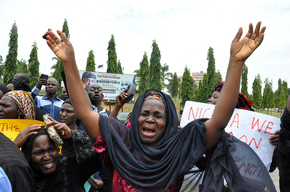 An unidentified mother cries out during a demonstration with others who have daughters among the kidnapped school girls of government secondary school Chibok, Tuesday April 29, 2014, in Abuja, Nigeria.  Two weeks after Islamic extremists stormed a remote boarding school in northeast Nigeria, more than 200 girls and young women remain missing despite a “hot pursuit” by security forces and desperate parents heading into a dangerous forest in search of their daughters. Some dozens have managed to escape their captors, jumping from the back of an open truck or escaping into the bush from a forest hideout, although the exact number of escapees is unclear. (AP Photo/ Gbemiga Olamikan)