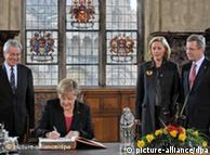 默克尔在不来梅市政厅留言，站着的是伍尔夫夫妇和不来梅市长博伦森