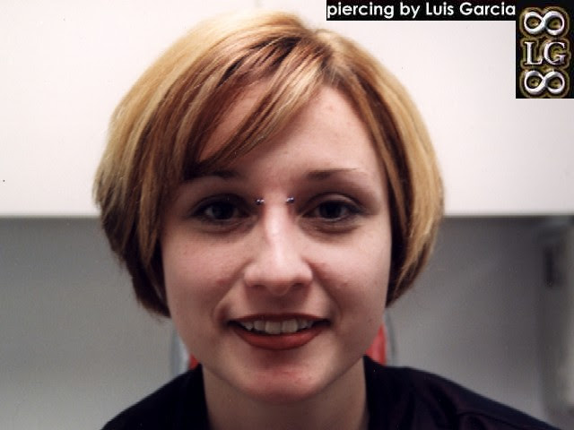 Bridge piercing with a 14ga 5/8" steel barbell with purple titanium balls.