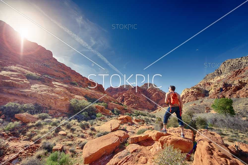 Man Looking At Sun Whilst Hiking At Red Rock Man