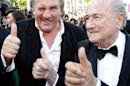 FIFA President Sepp Blatter, right, and actor Gerard Depardieu gives the thumbs up as they arrive for the screening of The Homesman at the 67th international film festival, Cannes, southern France, Sunday, May 18, 2014. (AP Photo/Thibault Camus)