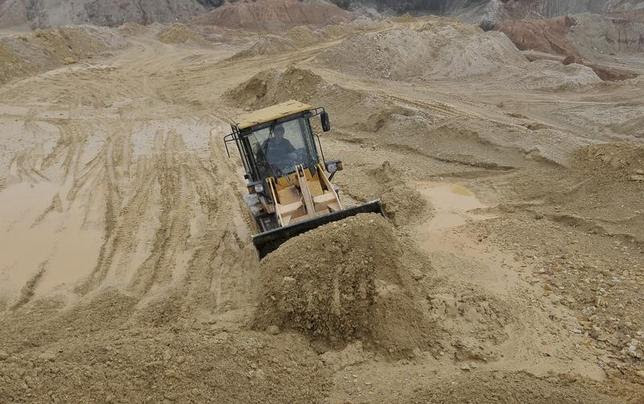 A labourer operates a bulldozer at a site of a rare earth metals mine at Nancheng county, Jiangxi province March 14, 2012. REUTERS/Stringer
