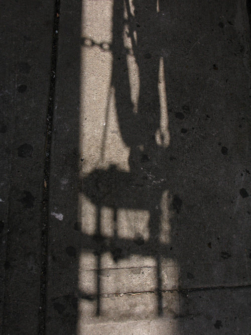 a shadow on a 37th Street sidewalk, Manhattan, NYC