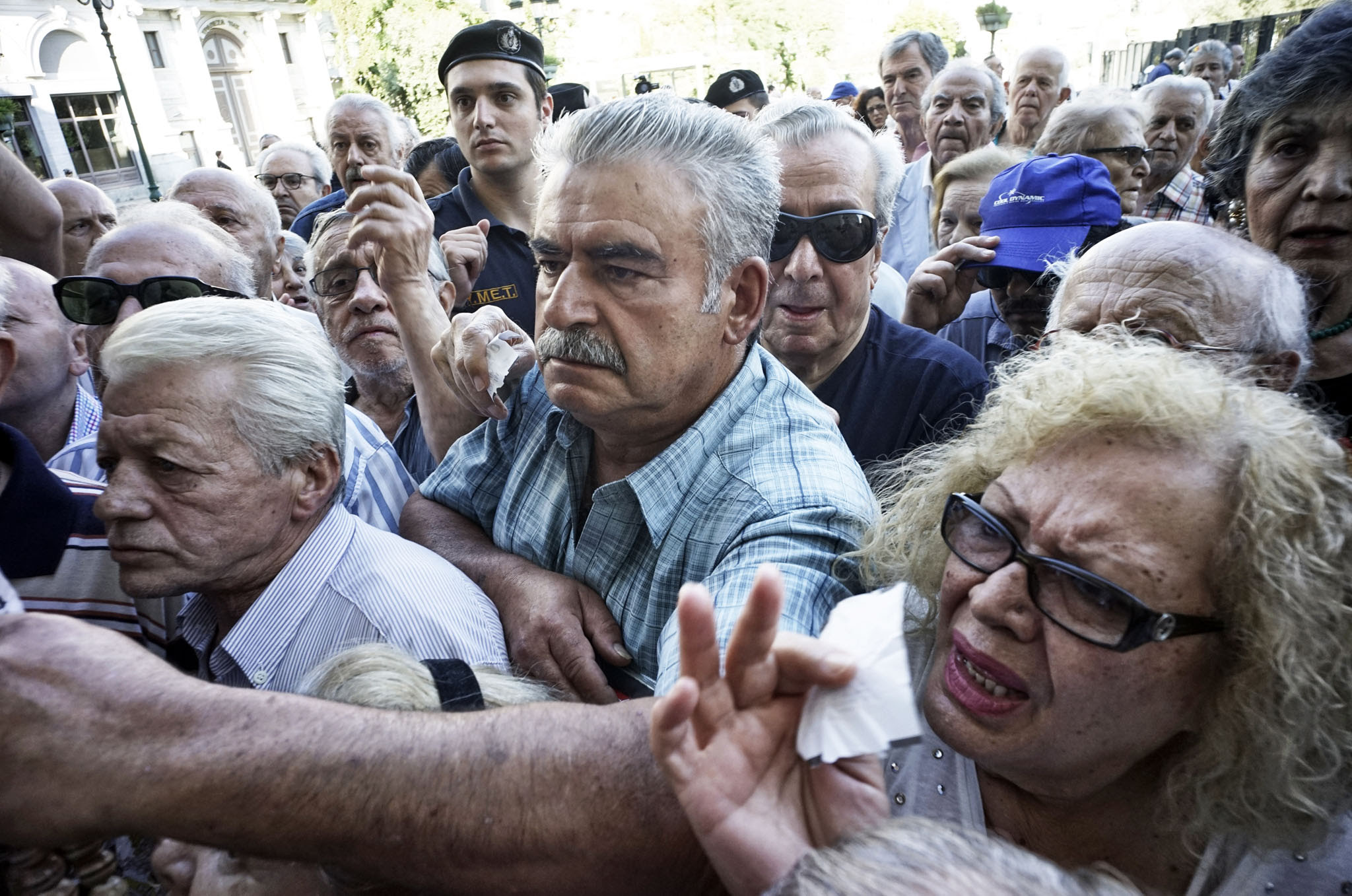 Pensioners line up outside a National Bank branch in Athens, Greece. 
