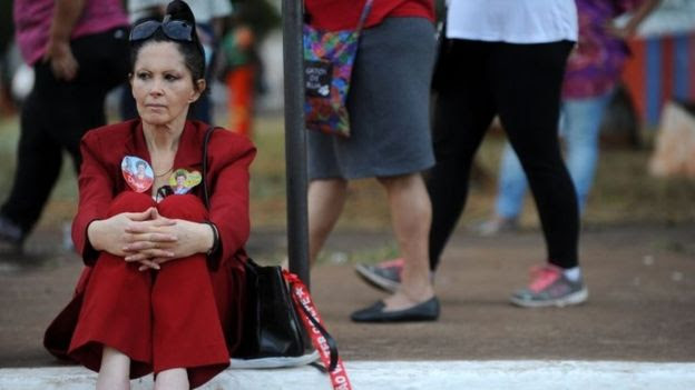A supporter of Brazilian President Dilma Rousseff sits during demonstration against her impeachment in front of the National Congress in Brasilia, on May 11, 2016.