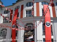 Red banners outside the theatre building with pretzels 