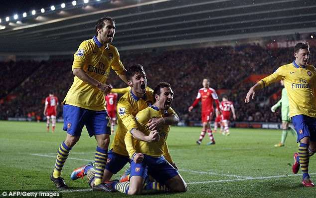 Yellow peril: Arsenal midfielder Santi Cazorla, centre, celebrates scoring his side's second against Southampton