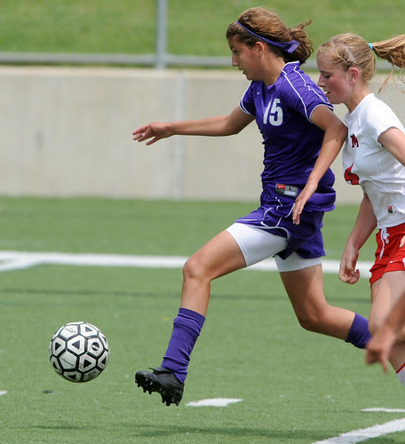 Pioneer High School's Megan Schechtman, left, races past Monroe High 