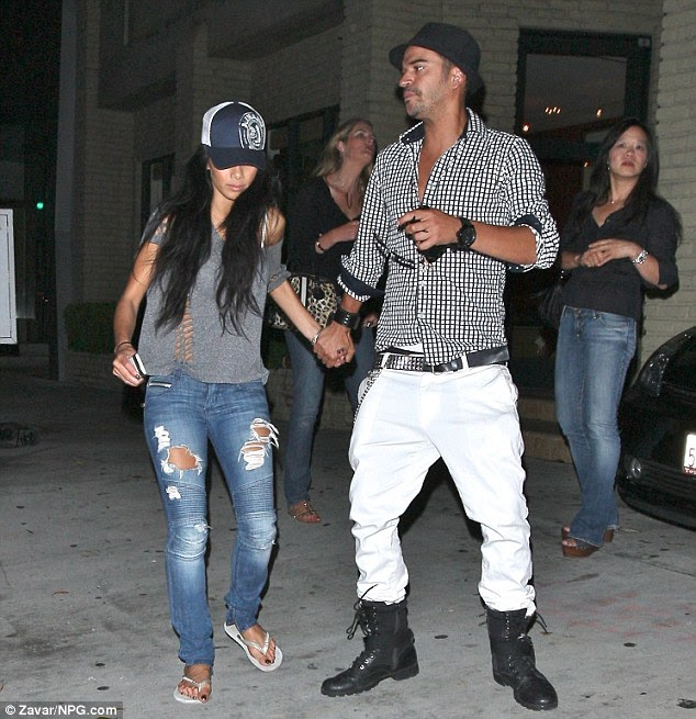 Home time: Clutching her friend;s hand, Nicole kept her head down as she called it a night