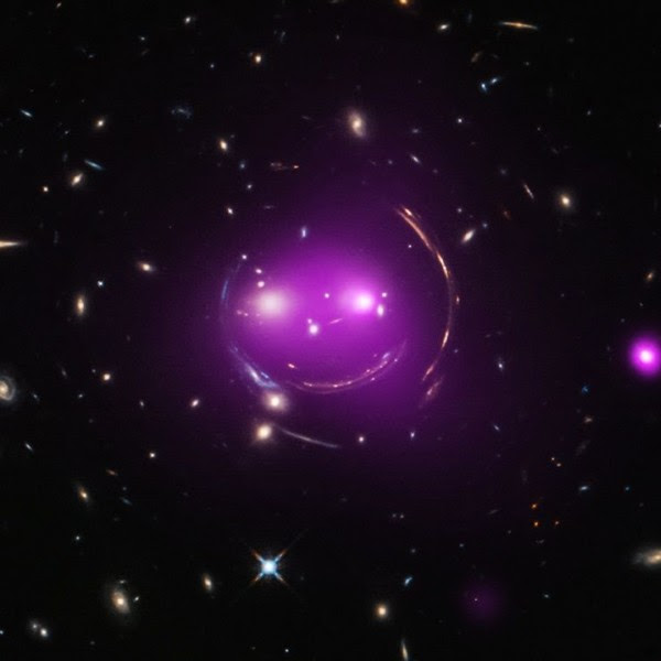 A composite image - combining x-ray and optical wavelengths - of the Cheshire Cat group of galaxies. Image via Chandra X-Ray Observatory.