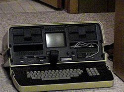 An opened Osborne 1 computer, ready for use. The keyboard sits on the inside of the lid.