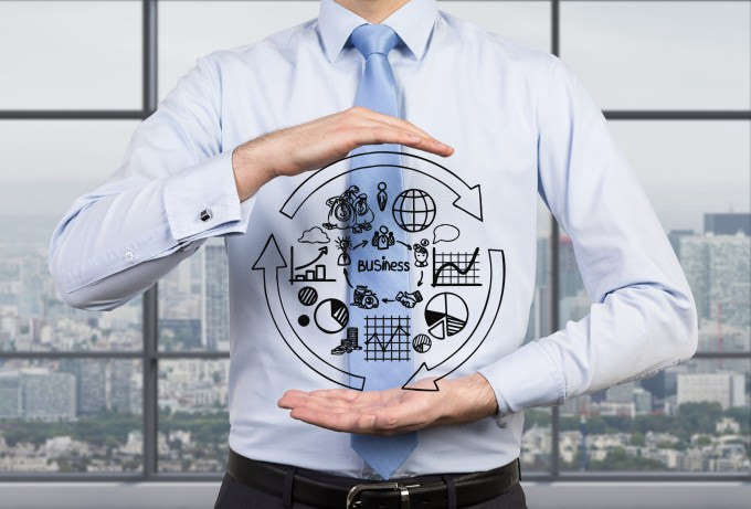 Big data concept picture of business man appearing to hold a drawing of loop with graphs and charts.