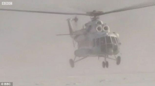 A chopper arrives as part of teh operation to airlift the Russian fisherman to safety
