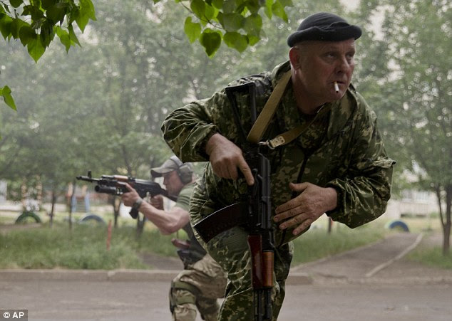 A rebel runs for cover during the clashes