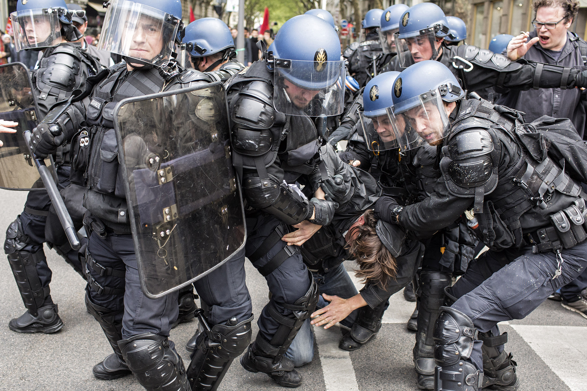 A protestor is arrested by riot police during a protest against the proposed changes to France's working week and layoff practices, in Lyon, central France