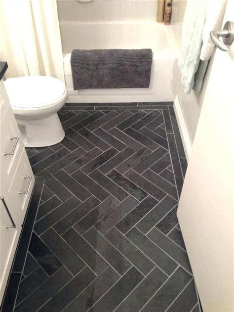 If your bathroom is in desperate need of an update, here are seven painted bathroom cabinet before and afters to inspire a colorful makeover. charcoal tile bathroom floor grey herringbone tile floor