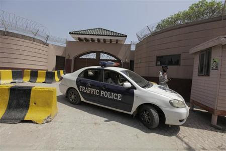 Police officers are seen outside the residence of Pakistan's former President and head of the All Pakistan Muslim League (APML) political party Pervez Musharraf, on the outskirts of Islamabad April 19, 2013. A Pakistani judge placed former president and army chief Pervez Musharraf under house arrest on Friday in the boldest step yet by the country's courts against senior military officers long deemed untouchable by the law. REUTERS-Faisal Mahmood