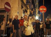 A man shoots into the sky as he celebrates the capture in Tripoli of Moammar Gadhafi's son and one-time heir apparent, Seif al-Islam, 