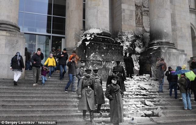 Generations: Tourists flock to the Reichstag in Berlin, where Russia's Marshal Zhukov stood in 1945
