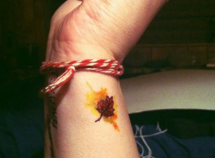 Tiny autumn leaf with watercolor explosion tattoo 29