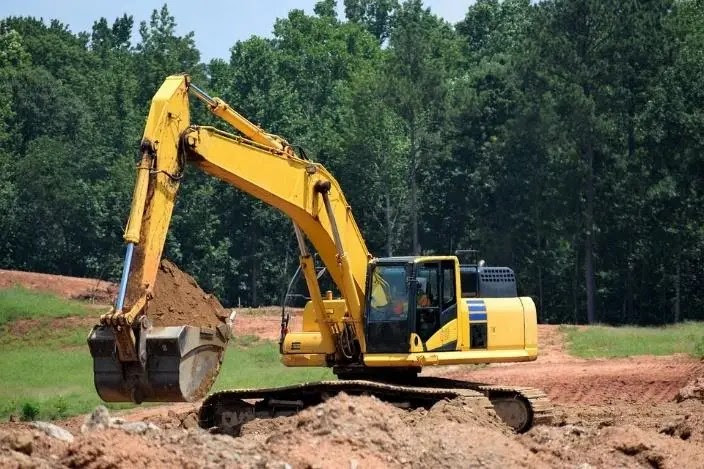 Construction car dug the ground for the foundation of the well