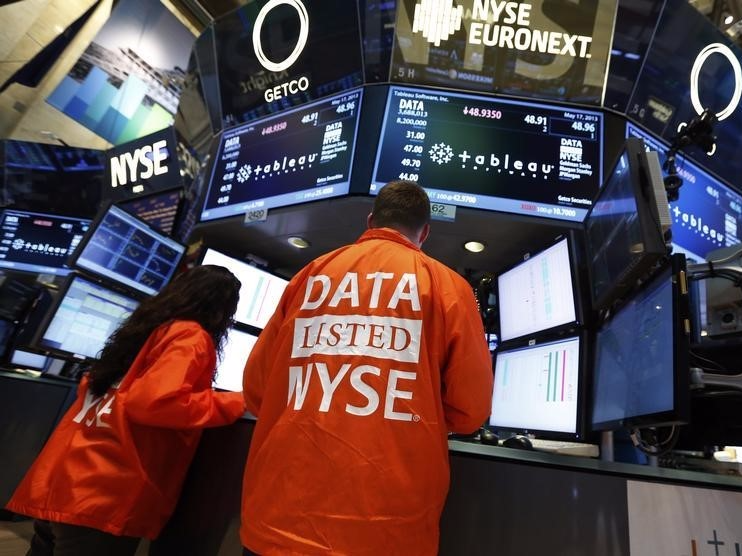 Getco Securities specialist traders work at the booth that trades Tableau Software on the floor of the New York Stock Exchange, in this May 17, 2013 file photo. REUTERS/Brendan McDermid