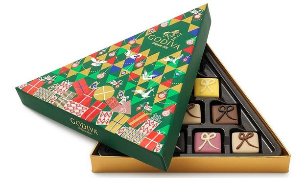 Godiva for world-famous chocolates that would be the perfect gift for chocolate lovers (so basically everyone) because they're delightfully rich and adorably packaged.