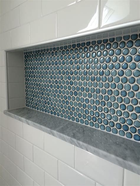 Installing tile on a floor is a beautiful choice. Penny tile shower nice | custom shower detail. inset niche