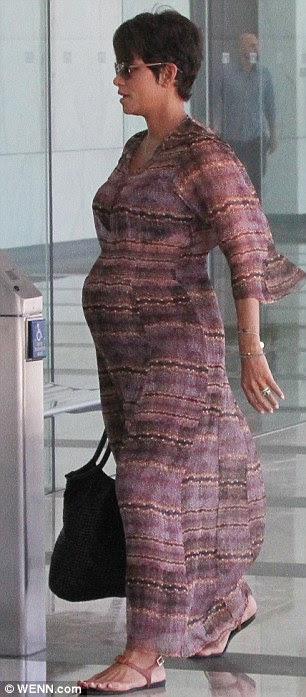 Blooming beautiful: Halle teamed the dress with a pair of flat sandals in the balmy weather