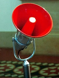 Electronic red megaphone on stand.