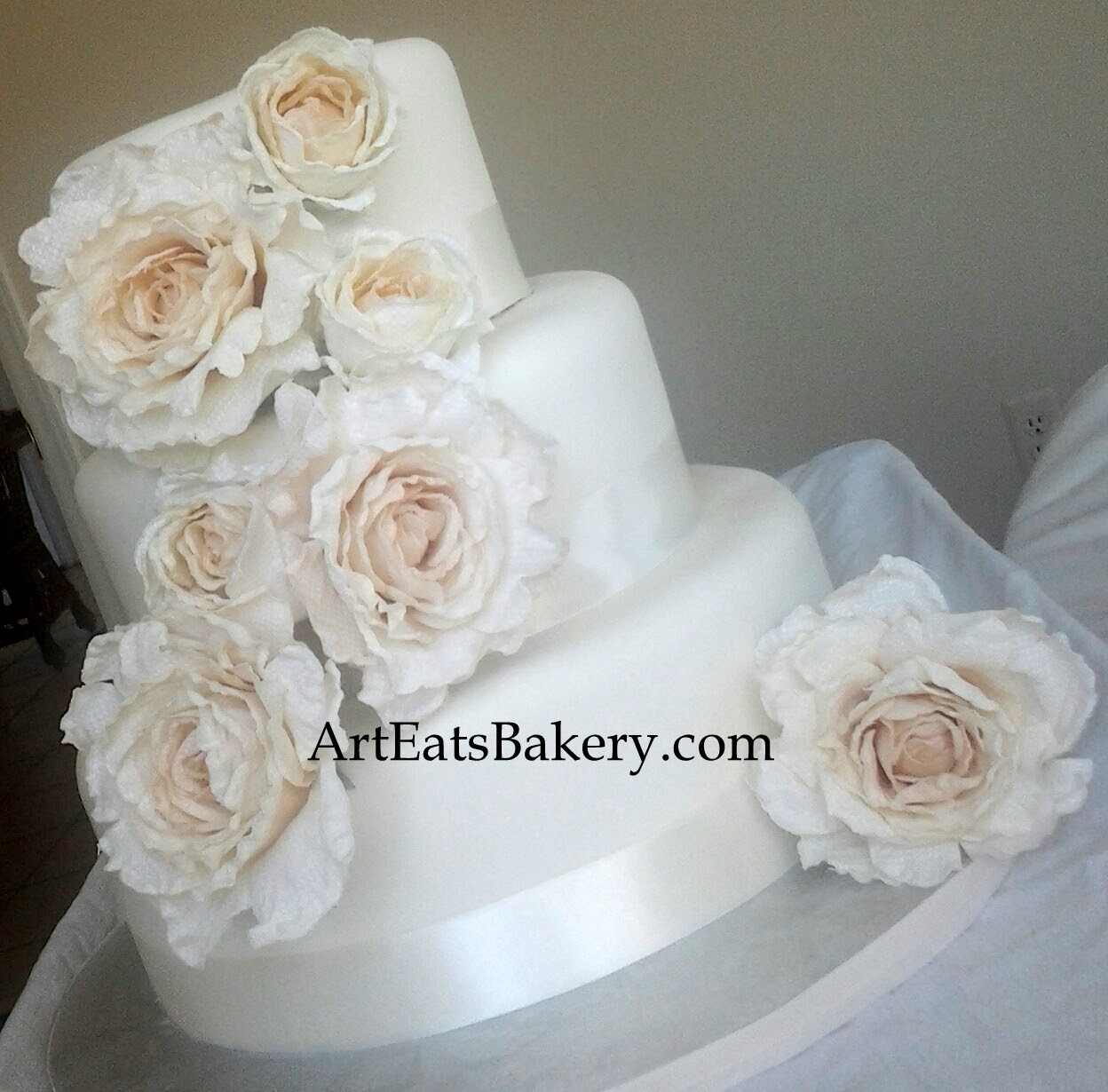 Three tier fondant modern unique wedding cake design with silk roses and ribbons.jpg