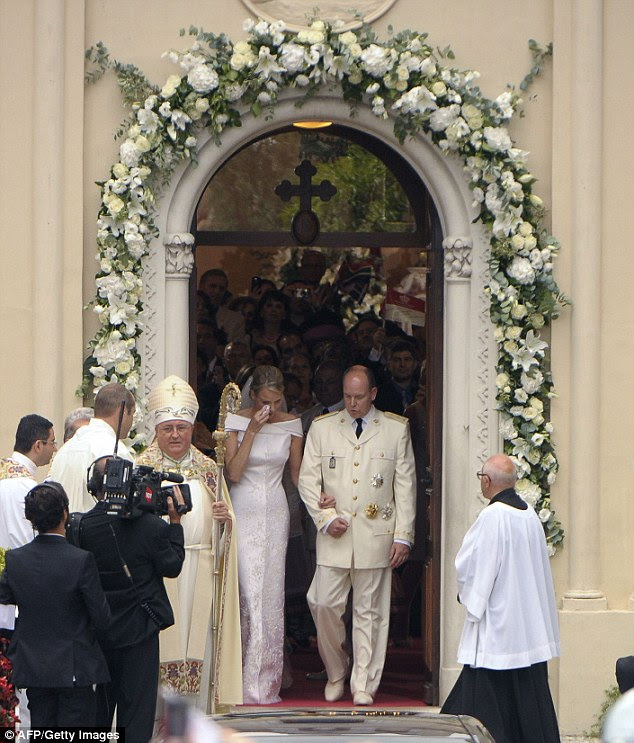 Emotional: Princess Charlene wipes away a tear as she leaves the Sainte Devote Church after placing her bouquet inside