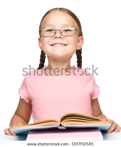 Cute little schoolgirl with a book wearing glasses, isolated over white - stock photo