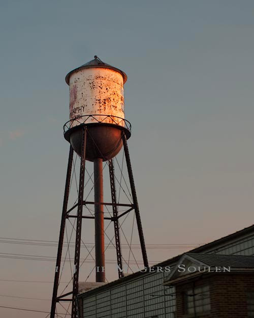 Old water tower with sunset glow.
